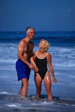 Bild av äldre par spelar på stranden