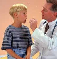 Bild på en läkare undersöker en ung pojke